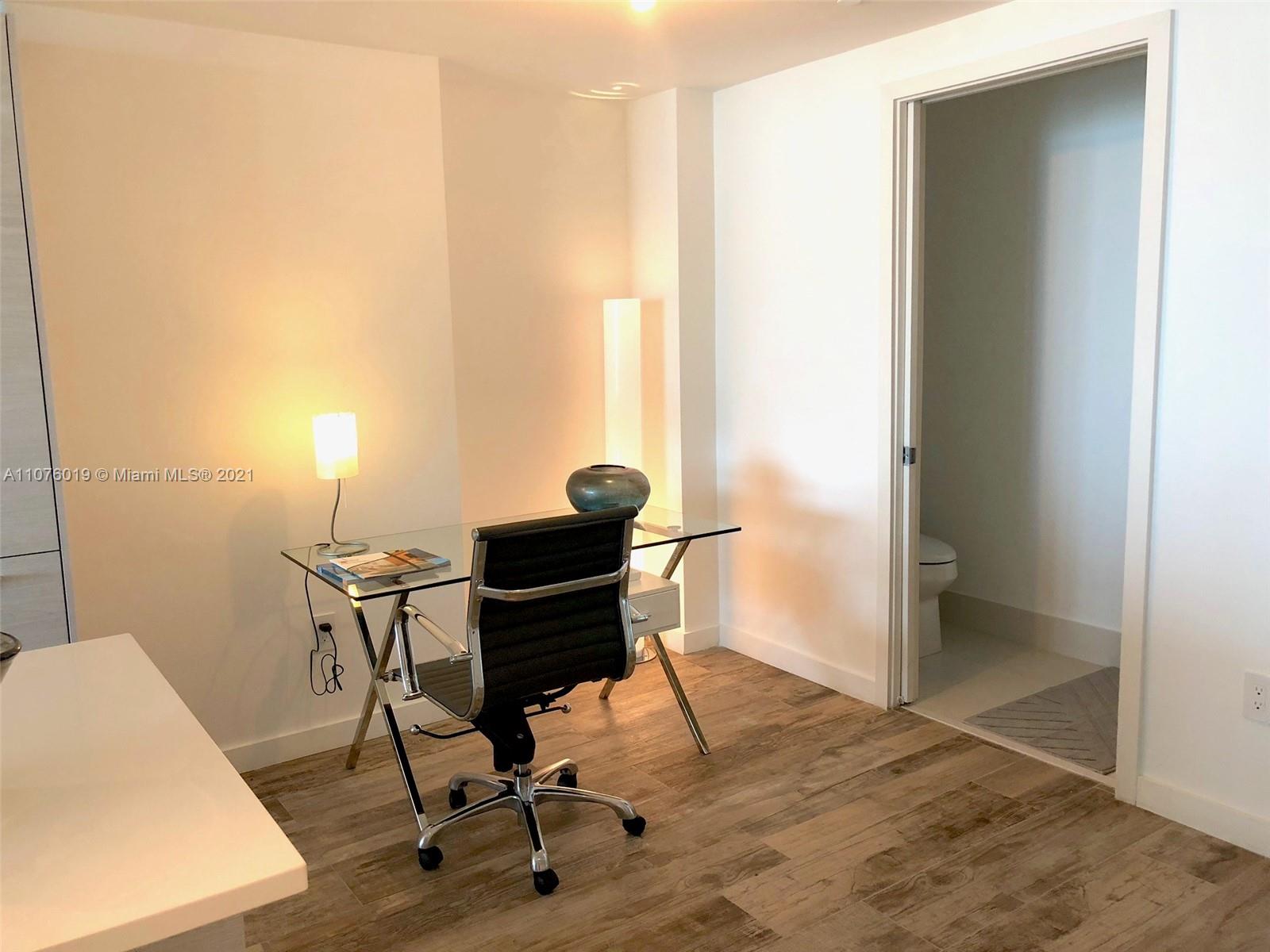 650 Northeast 32nd Street, Unit 4103 Miami, FL 33137 - Photo 3 of 44 a view of a workspace with furniture and a window