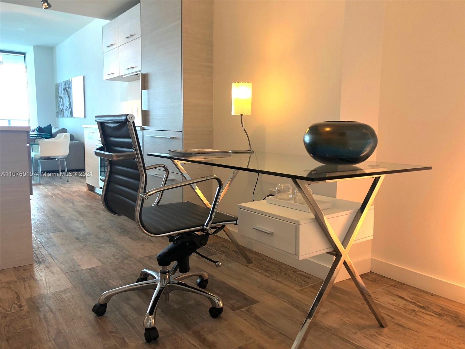 650 Northeast 32nd Street, Unit 4103 Miami, FL 33137 - Photo 4 of 44 a room with a chair and white walls