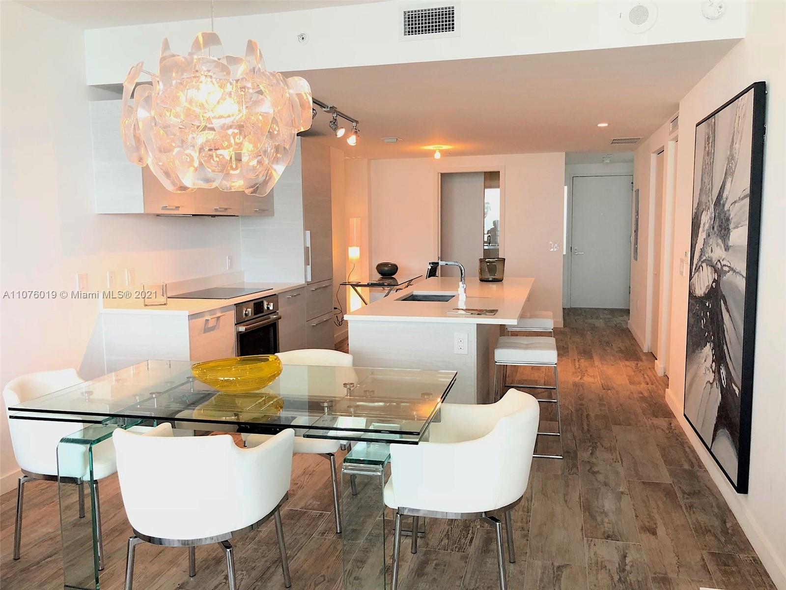 650 Northeast 32nd Street, Unit 4103 Miami, FL 33137 - Photo 9 of 44 a living room with furniture and a flat screen tv