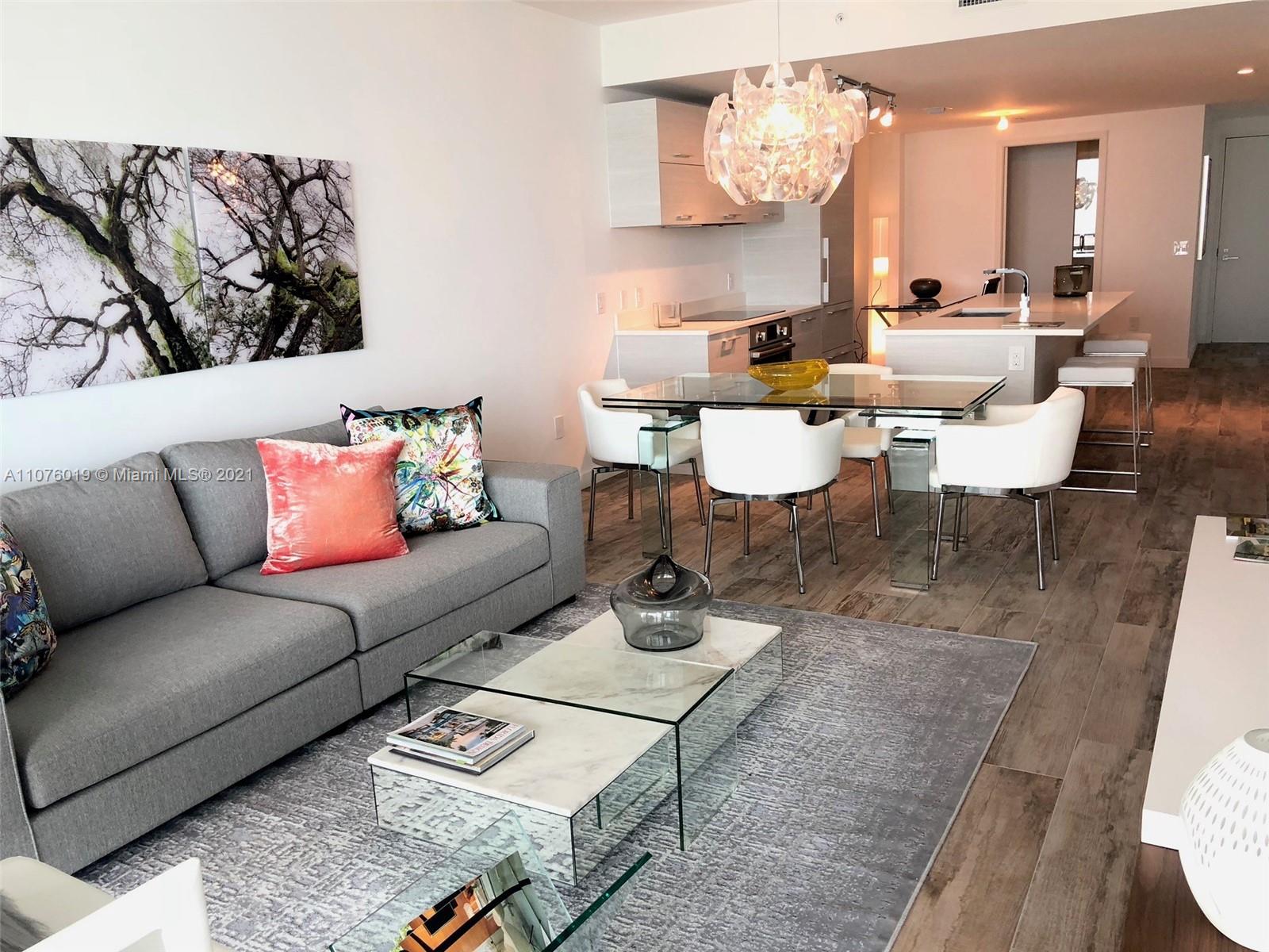 650 Northeast 32nd Street, Unit 4103 Miami, FL 33137 - Photo 10 of 44 a living room with furniture and a chandelier