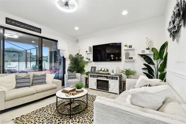 a large kitchen with stainless steel appliances granite countertop a stove a refrigerator a oven a sink a dining table and chairs with wooden floor