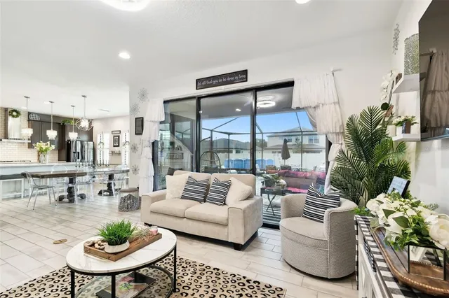 a view of a dining room with furniture and a chandelier