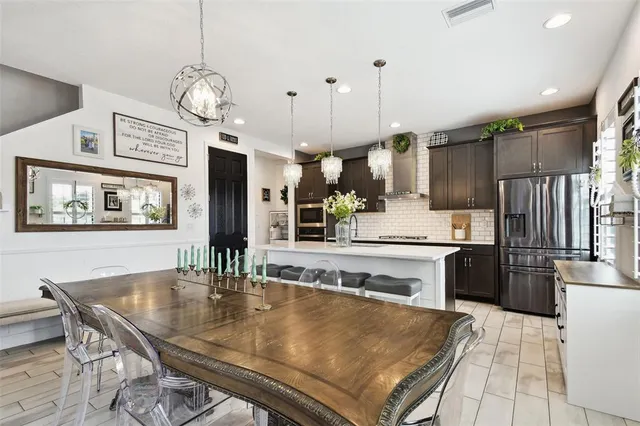 a kitchen with granite countertop a refrigerator and a sink