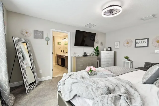 a living room with furniture and a baby crib