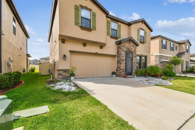 a backyard of a house with a garden and barbeque oven