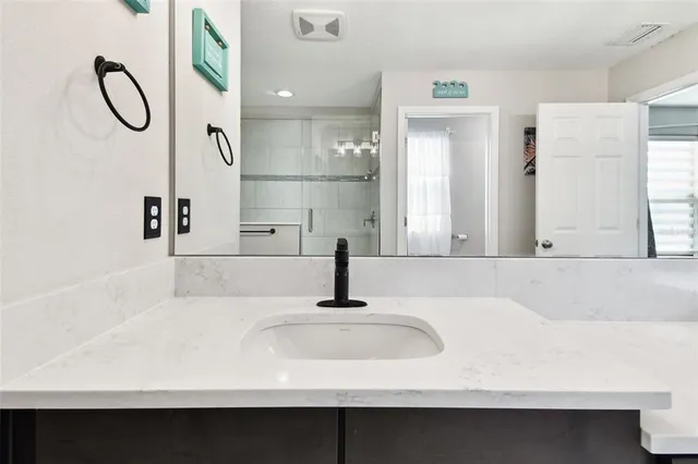 a front view of a house with a yard and potted plants