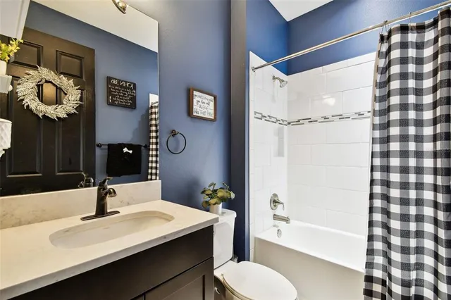 a living room with furniture potted plant and a large window