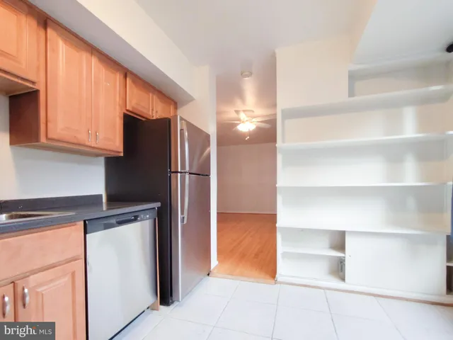 a kitchen with cabinets and stainless steel appliances