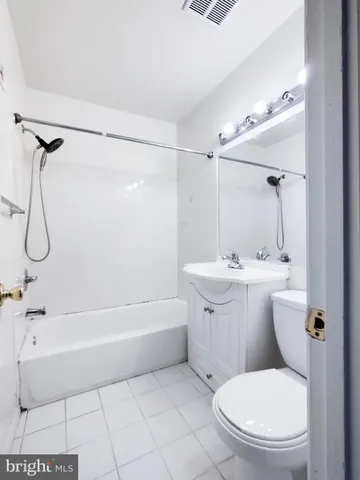 a bathroom with a toilet bathtub and shower