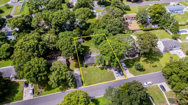 an aerial view of a house with a yard
