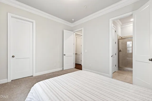 a bedroom with a bed and a bathroom