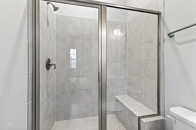 a bathroom with a glass shower door