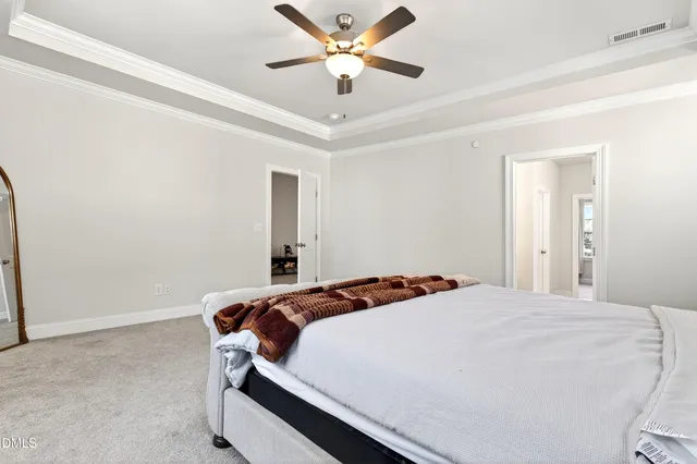 a bedroom with a bed and a ceiling fan