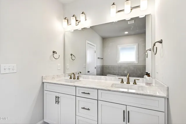 a bathroom with a sink double vanity and a mirror
