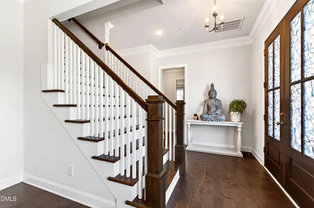 a view of entryway bedroom and hall with wooden floor