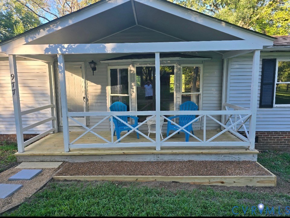 977 Burchs Mill Road Urbanna, VA 23175 - Photo 35 of 38 Covered front porch with natural wood-finish deck