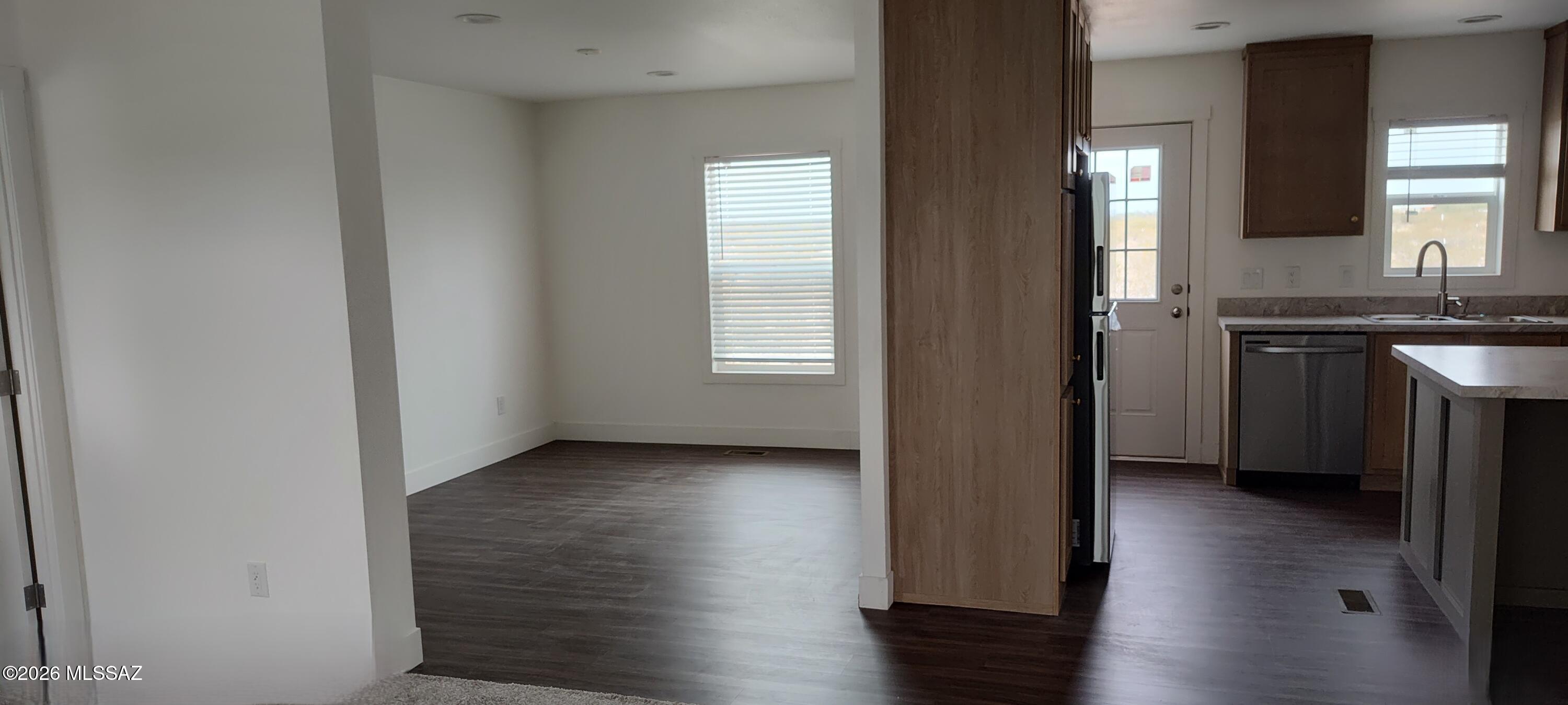 18565 West McClean Road Marana, AZ 85653 - Photo 10 of 37 an empty room with wooden floor and windows