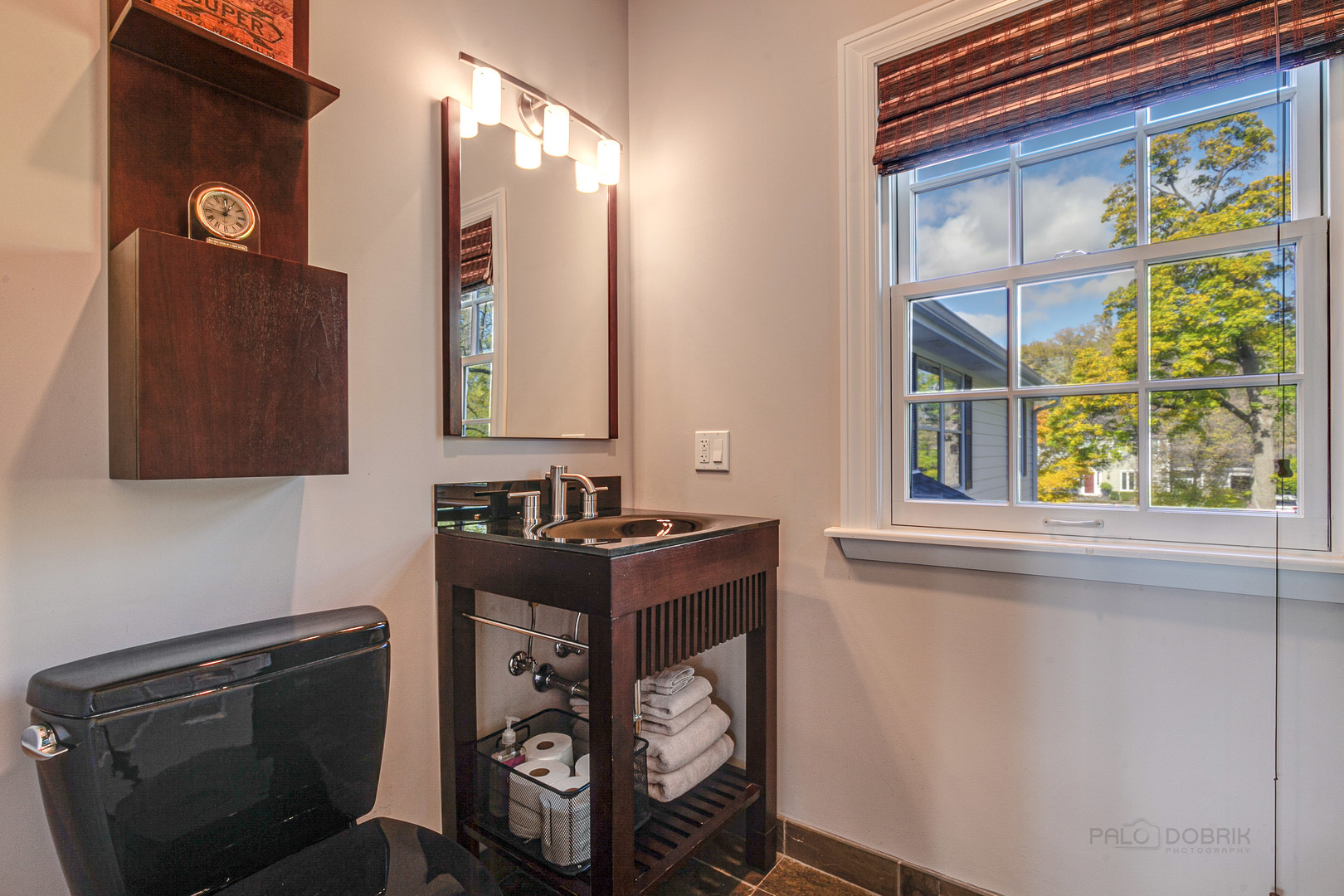 1267 West Deerpath Road Lake Forest, IL 60045 - Photo 28 of 47 a bathroom with a sink a mirror and a window