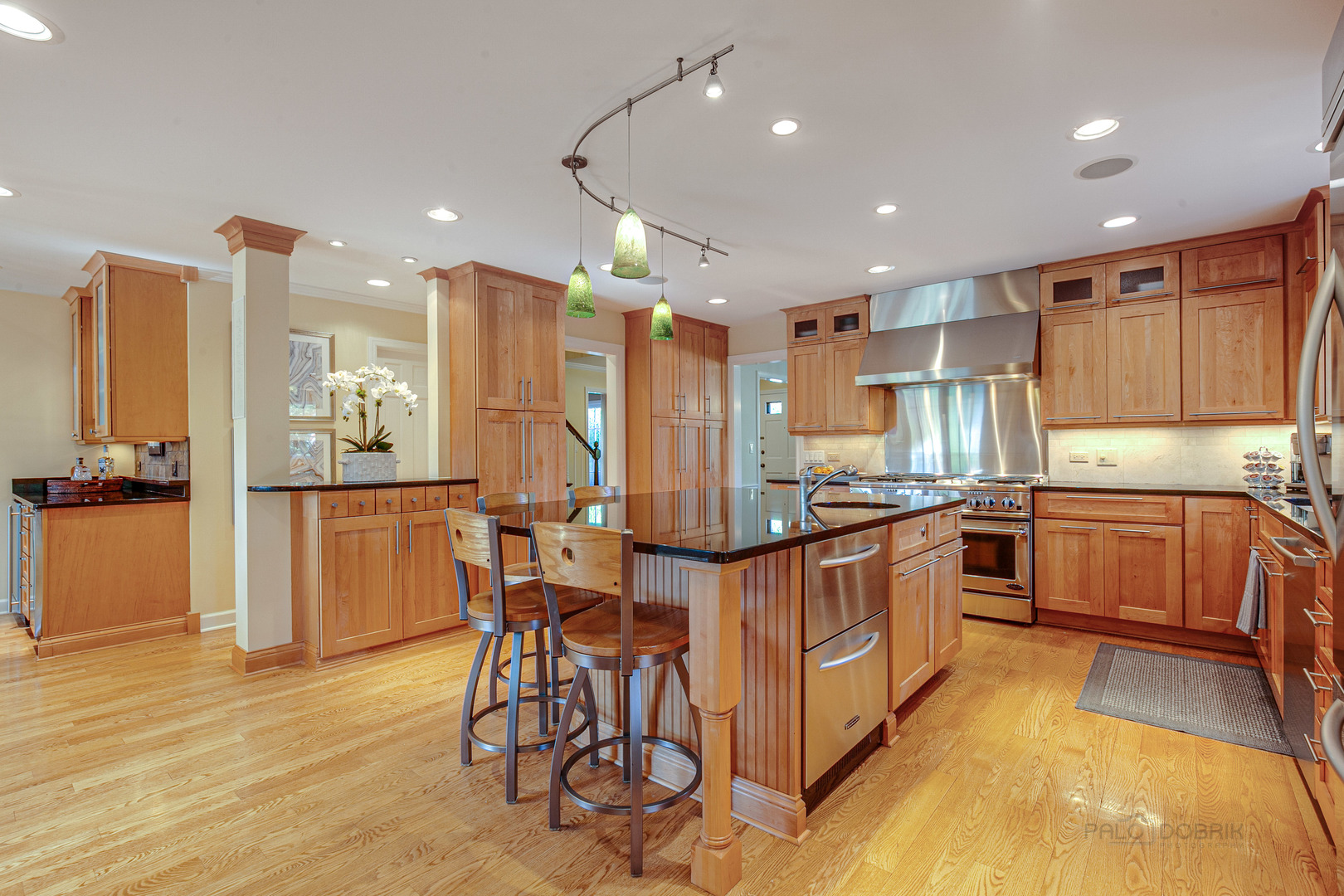 1267 West Deerpath Road Lake Forest, IL 60045 - Photo 9 of 47 a kitchen with stainless steel appliances kitchen island granite countertop a table and chairs in it