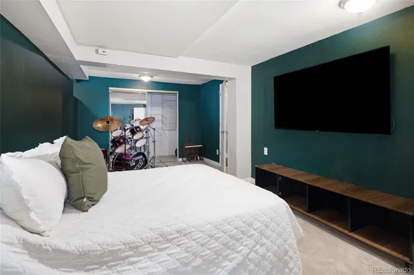 a bed room with a bed and a television
