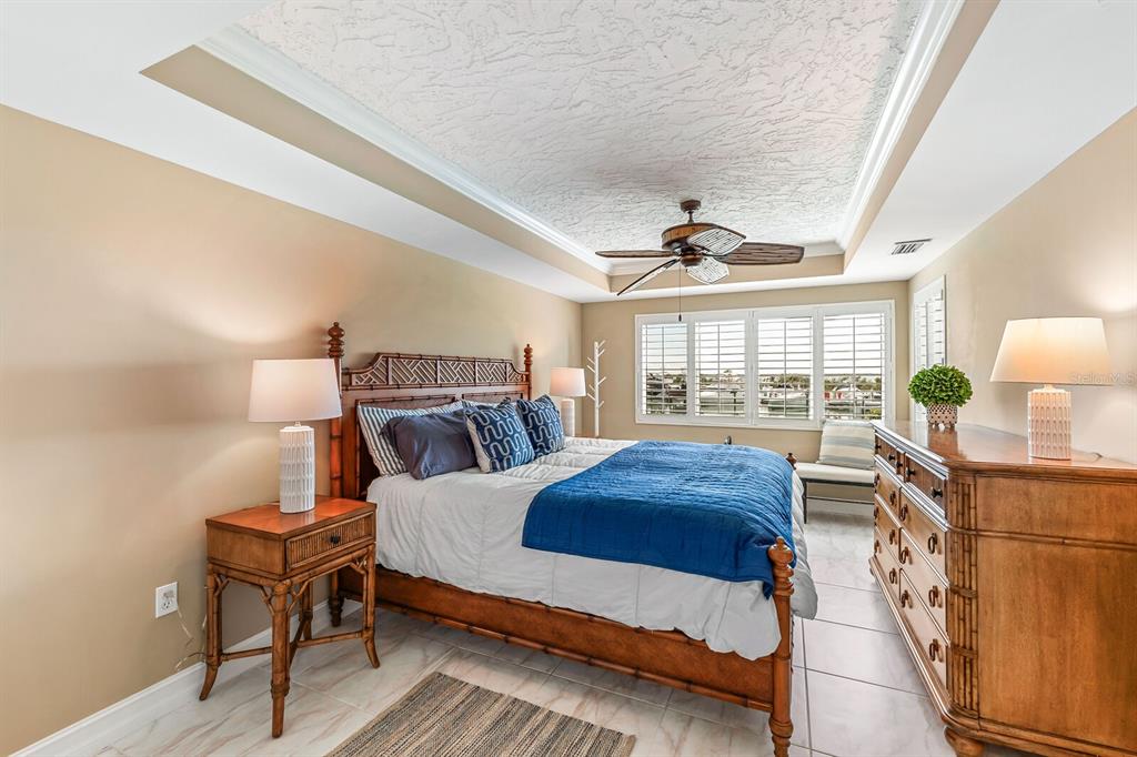 5852 Gasparilla Road, Unit MV13 Boca Grande, FL 33921 - Photo 7 of 37 a bedroom with a bed a lamp and window