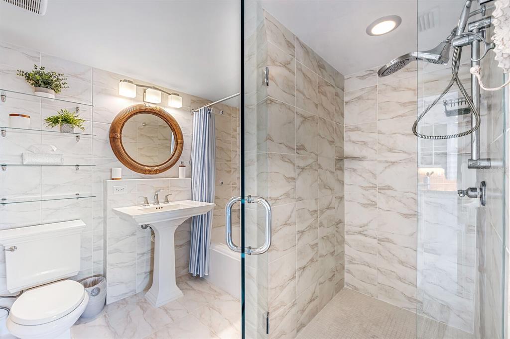 5852 Gasparilla Road, Unit MV13 Boca Grande, FL 33921 - Photo 8 of 37 a bathroom with a toilet sink vanity granite and a shower