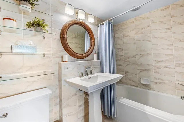 a bathroom with a sink a toilet and a bathtub