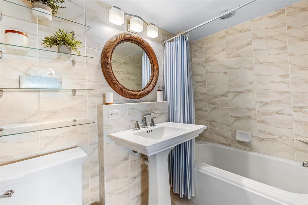 5852 Gasparilla Road, Unit MV13 Boca Grande, FL 33921 - Photo 9 of 37 a bathroom with a sink a toilet and a bathtub