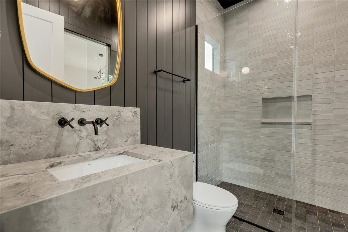 807 Chamberlain Street Raleigh, NC 27607 - Photo 18 of 40 a bathroom with a sink toilet and shower