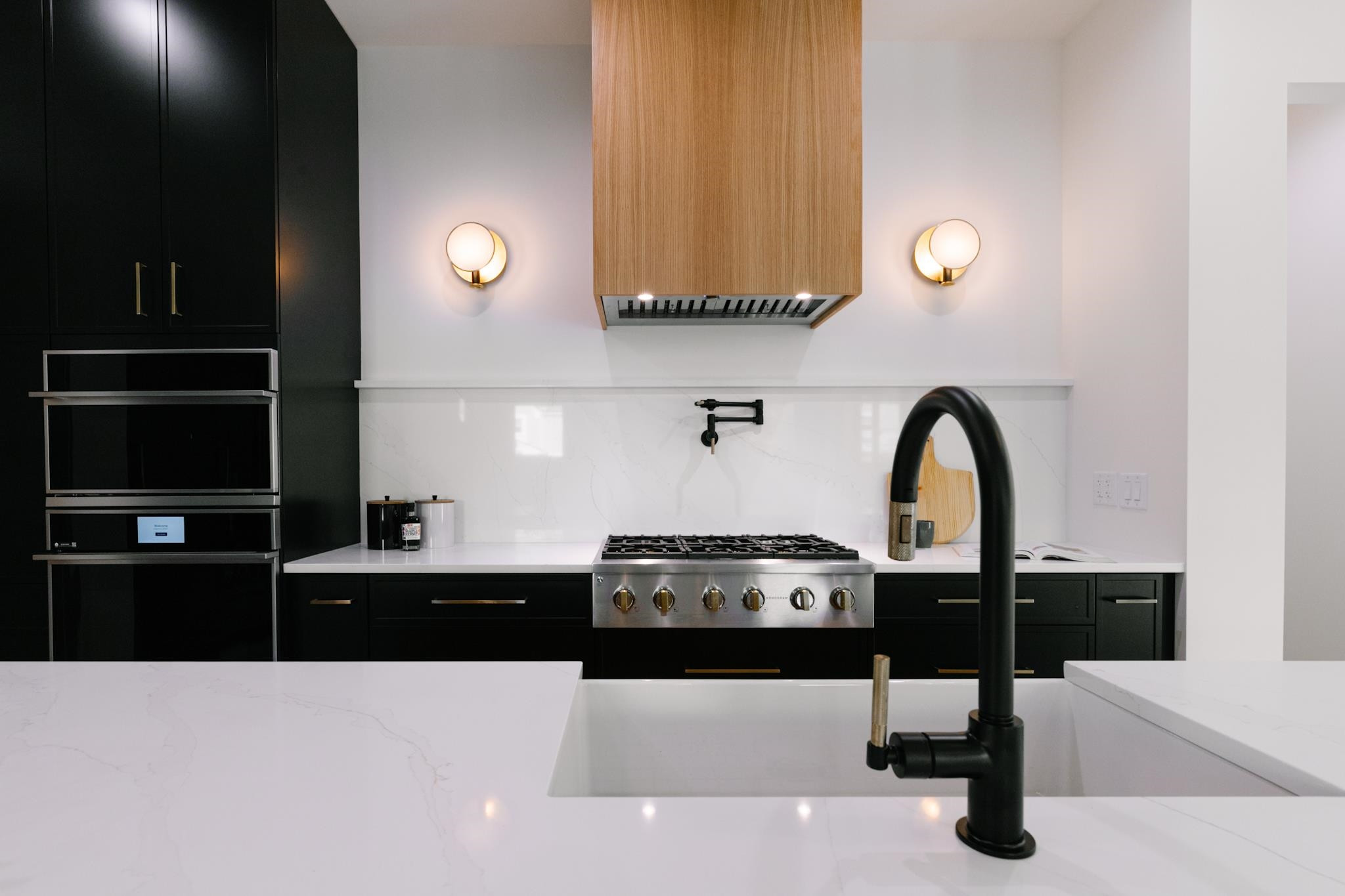 807 Chamberlain Street Raleigh, NC 27607 - Photo 29 of 40 a kitchen with a sink a stove and cabinets
