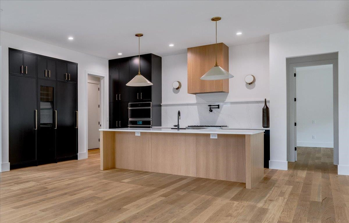 807 Chamberlain Street Raleigh, NC 27607 - Photo 31 of 40 a large kitchen with stainless steel appliances granite countertop a refrigerator a sink and a stove