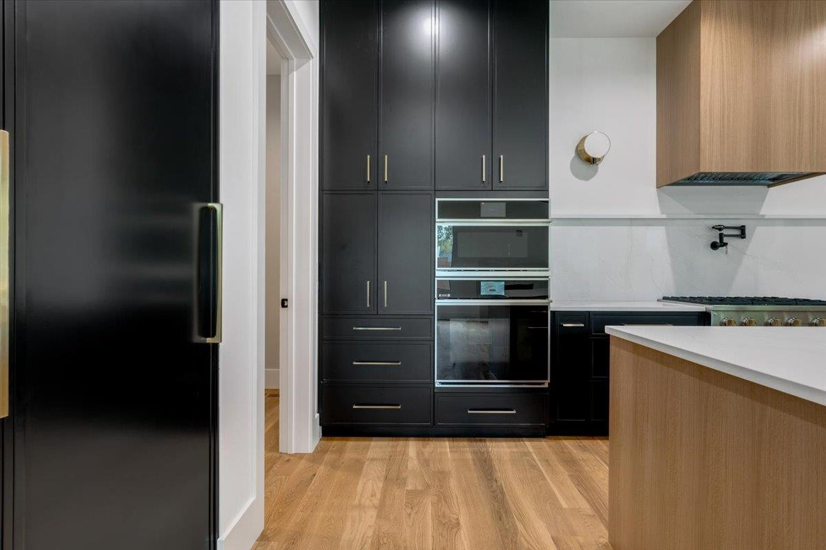 807 Chamberlain Street Raleigh, NC 27607 - Photo 35 of 40 a kitchen with granite countertop a refrigerator and a stove