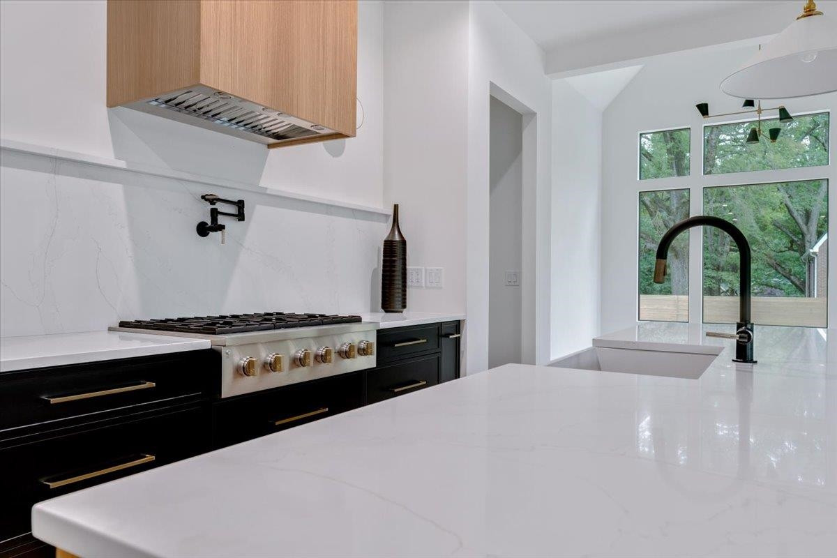 807 Chamberlain Street Raleigh, NC 27607 - Photo 36 of 40 a kitchen with a stove a sink and a refrigerator