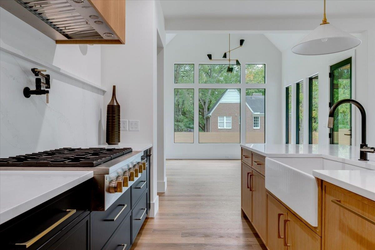 807 Chamberlain Street Raleigh, NC 27607 - Photo 37 of 40 a kitchen with granite countertop a stove and a sink