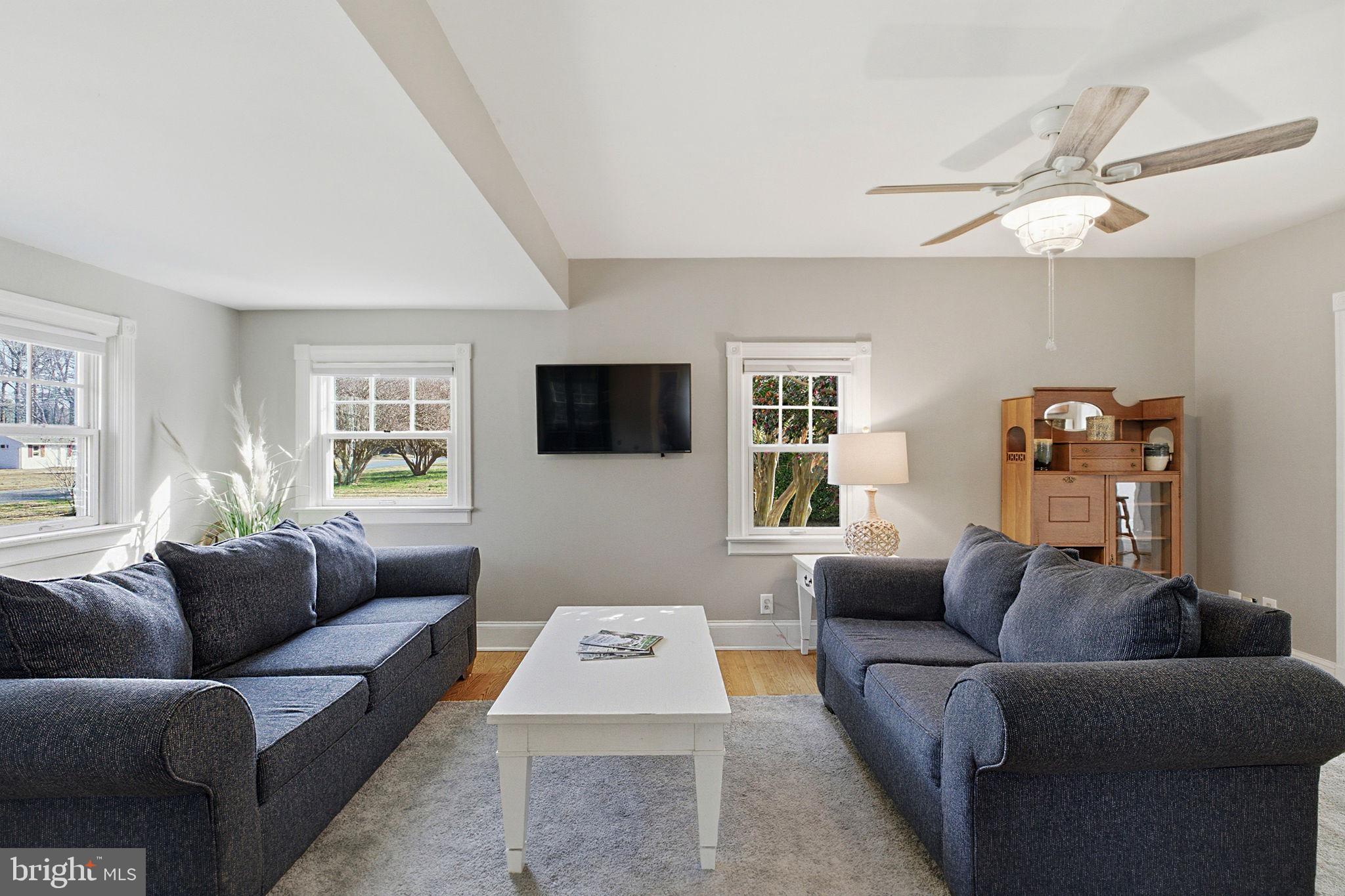 519 Whitehall Road Lancaster, VA 22503 - Photo 14 of 46 a living room with furniture and a flat screen tv