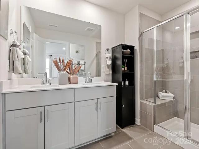 a bathroom with a double vanity sink and mirror