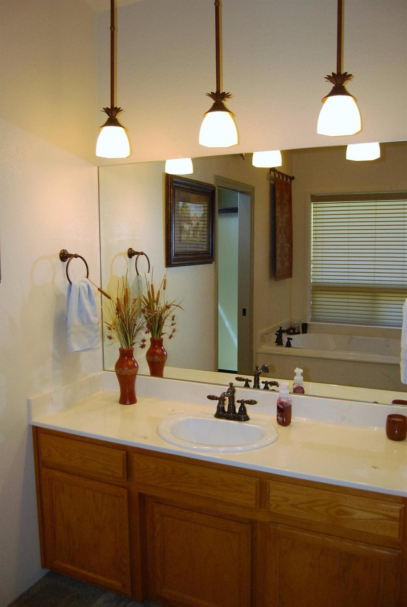 1136 Grouse Ridge Drive Central Point, OR 97502 - Photo 19 of 35 a bathroom with a sink and a mirror