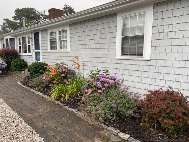 101 Lower County Road, Unit 2B Dennis Port, MA 02639 - Photo 24 of 28 a flower garden is sitting in front of a house