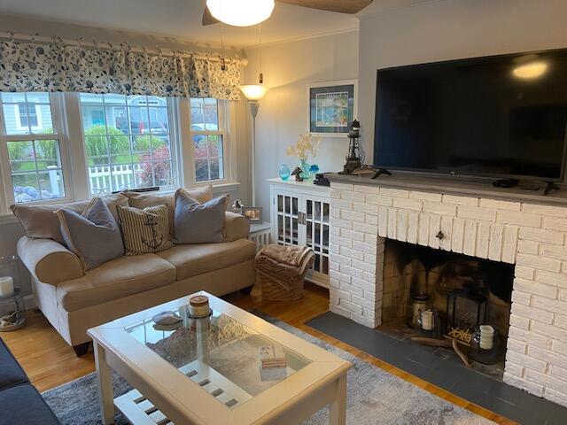 101 Lower County Road, Unit 2B Dennis Port, MA 02639 - Photo 3 of 28 a living room with furniture a flat screen tv and a fireplace
