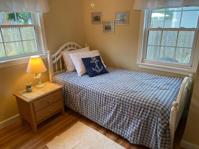 101 Lower County Road, Unit 2B Dennis Port, MA 02639 - Photo 10 of 28 a bedroom with a bed and wooden floor
