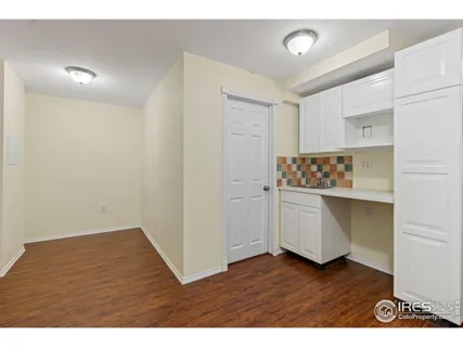 a view of an empty walk in closet with wooden floor