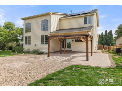 a view of a house with backyard and trees
