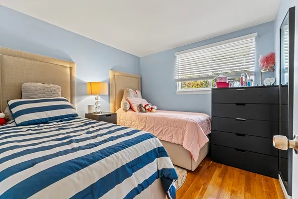 a bedroom with two beds and a window