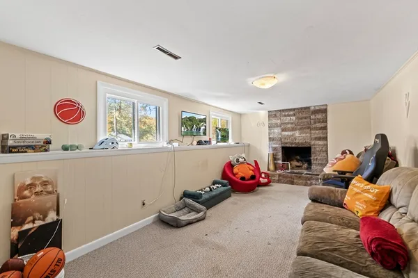 a living room with furniture a flat screen tv and a fireplace