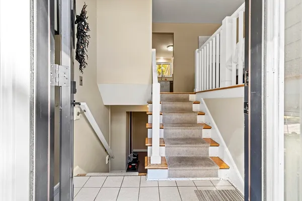 a view of staircase with white walls and windows