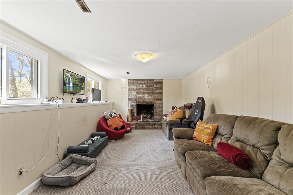 6 Tall Tree Road Sharon, MA 02067 - Photo 21 of 24 a living room with furniture fireplace and window