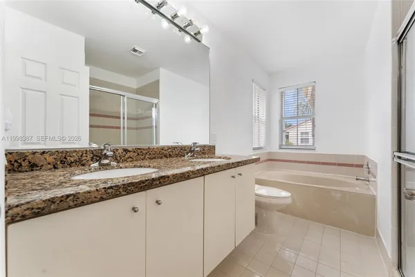 a bathroom with a glass shower door