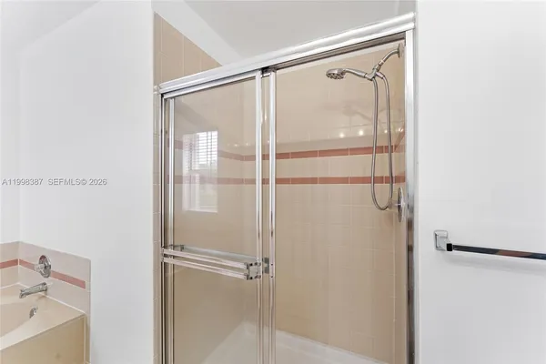 a view of a livingroom with wooden floor and a ceiling fan