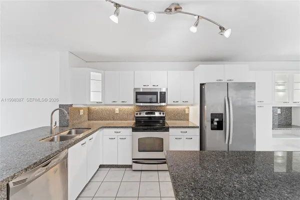 a kitchen with stainless steel appliances a stove sink and refrigerator