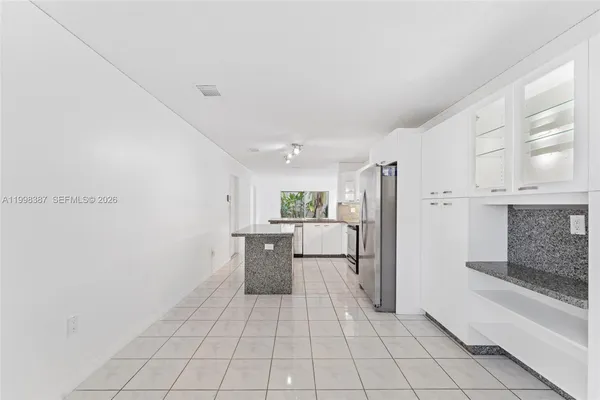 a view of a kitchen with a sink and dishwasher cabinets